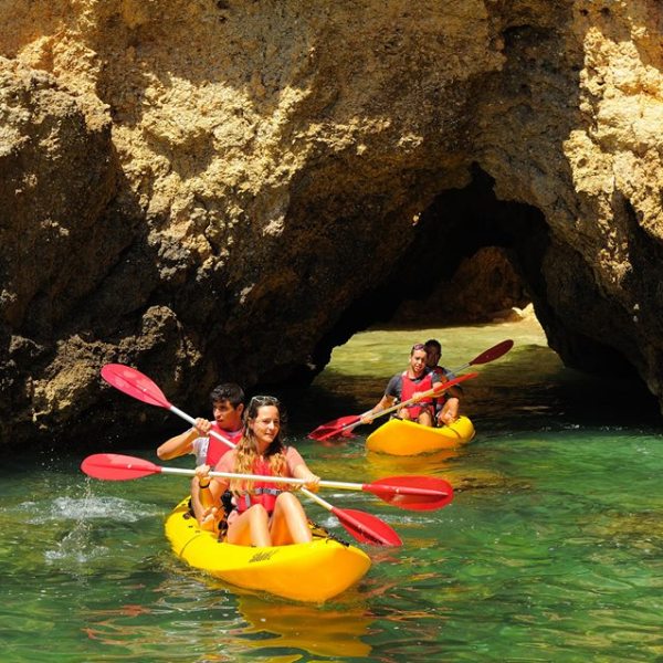 4 people on two yellow kayaks