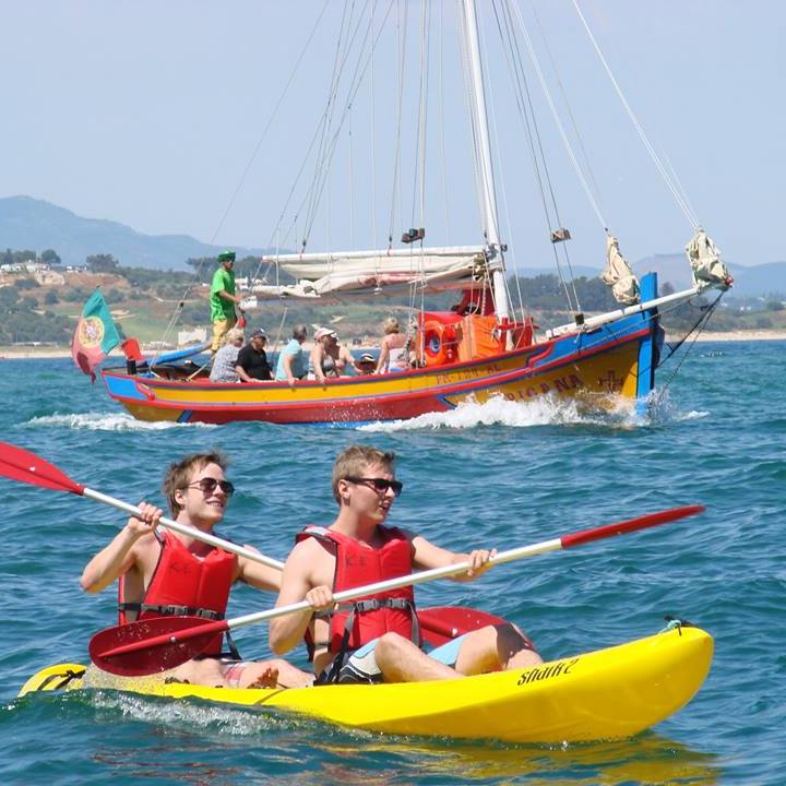 a kayak and a boat in the back