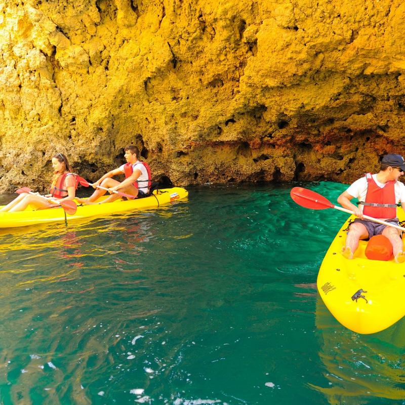 two yellow kayaks with people on it