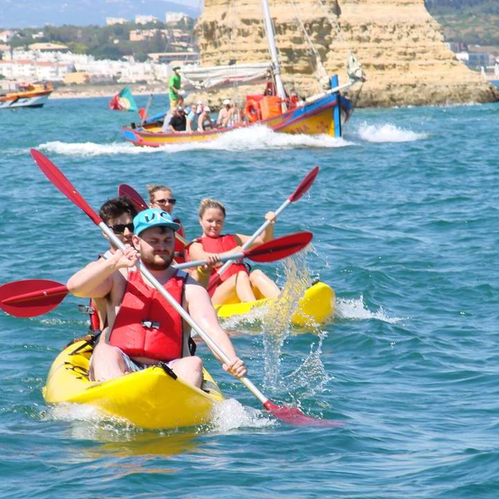 4 people riding 2 yellow kayaks