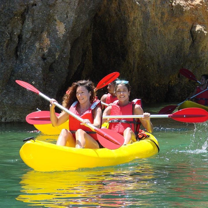 two girls having fun while kayaking