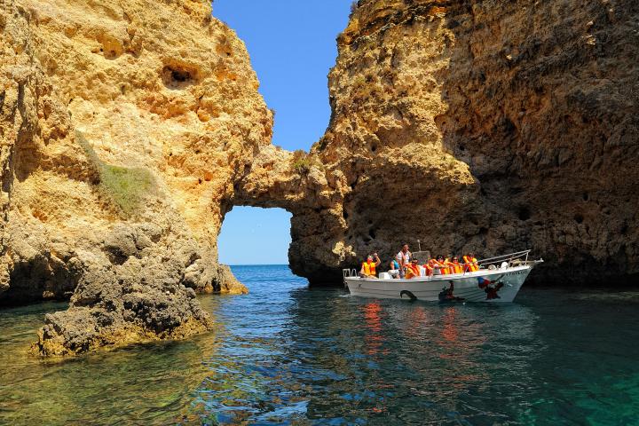 boat sailing near rocks