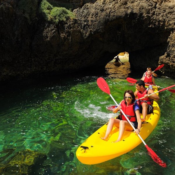 people paddling on two yellow kayaks